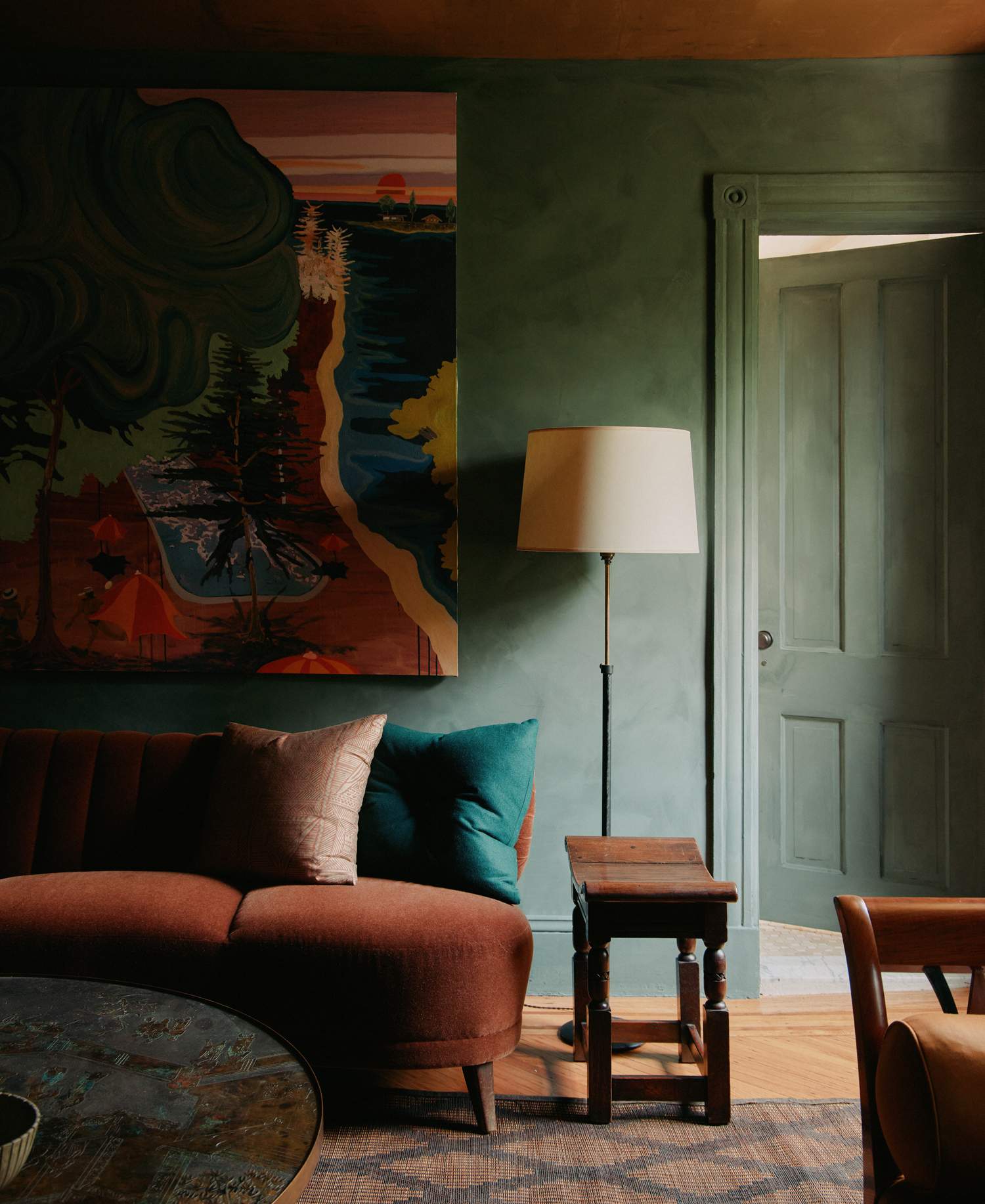 Room with a large textile artwork above a sofa, rug 15369