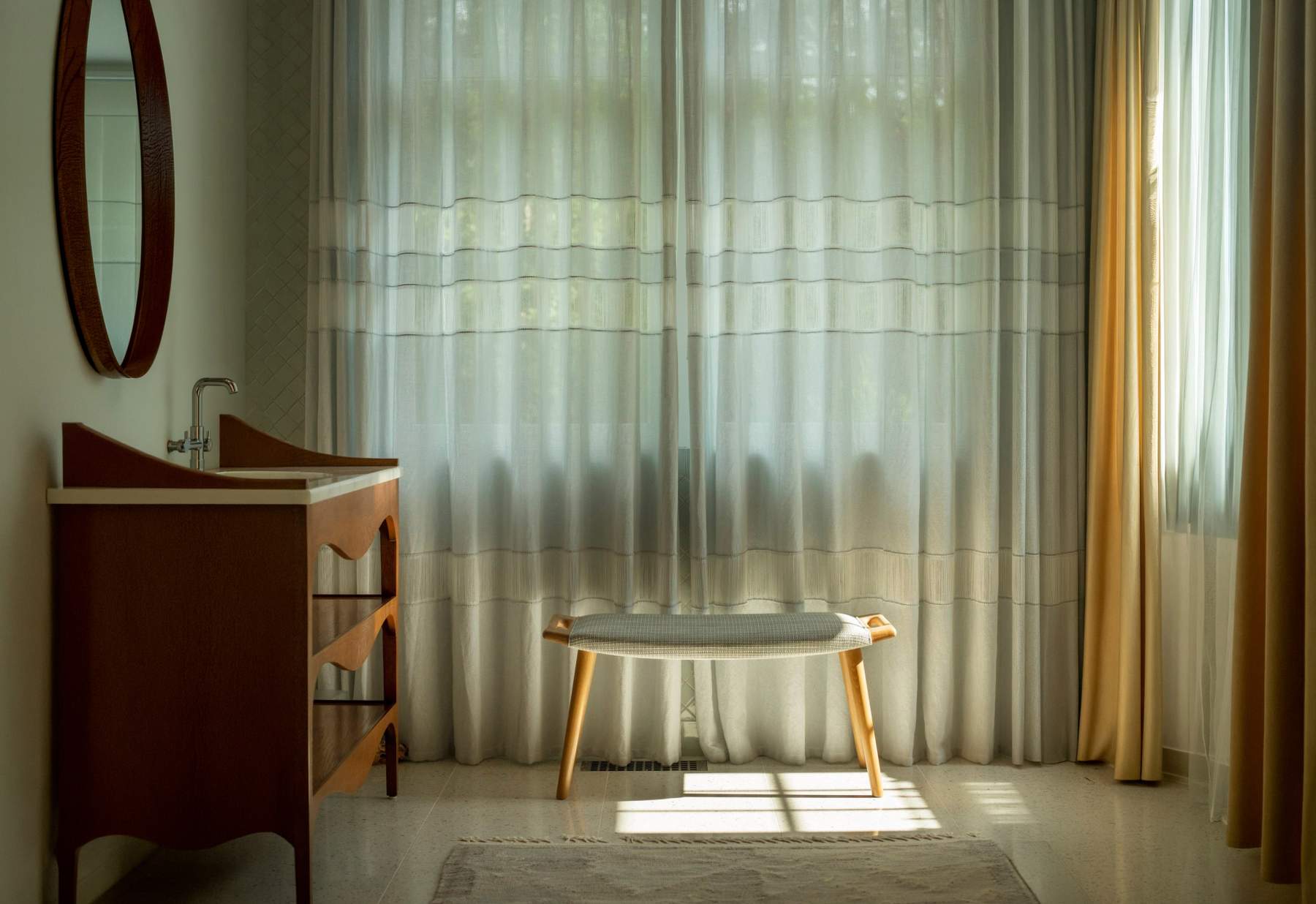 Sheer curtains in a sunlit bathroom